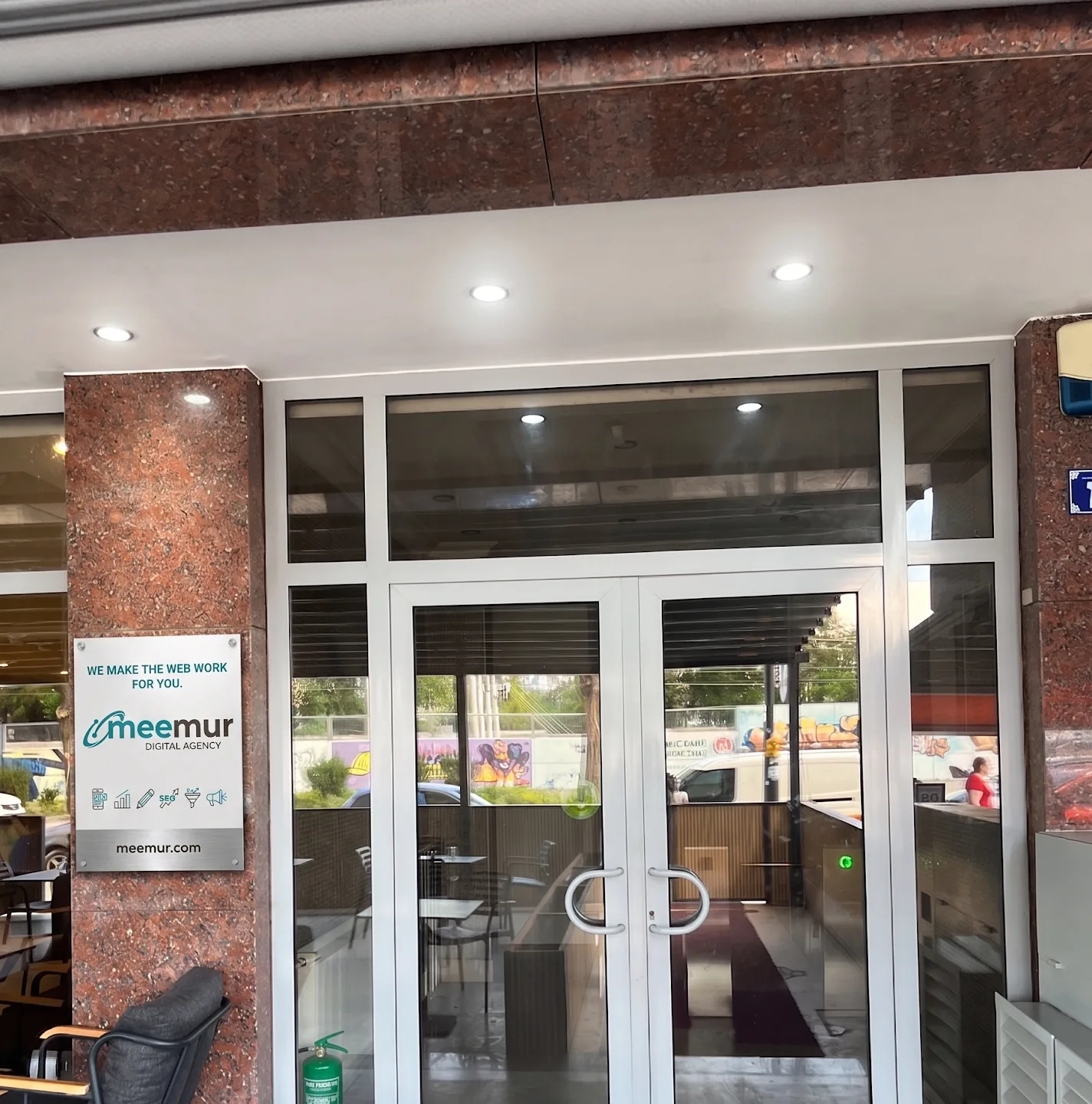 The meemur studio storefront in Ankara, a glass-door entrance with signage reading “We make the web work for you.”